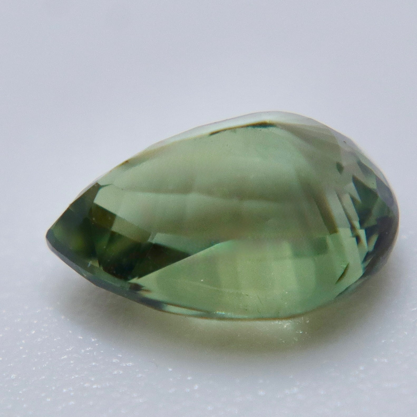 1.16 carat Ceylon alexandrite displaying warm brown and golden tones under warm lighting