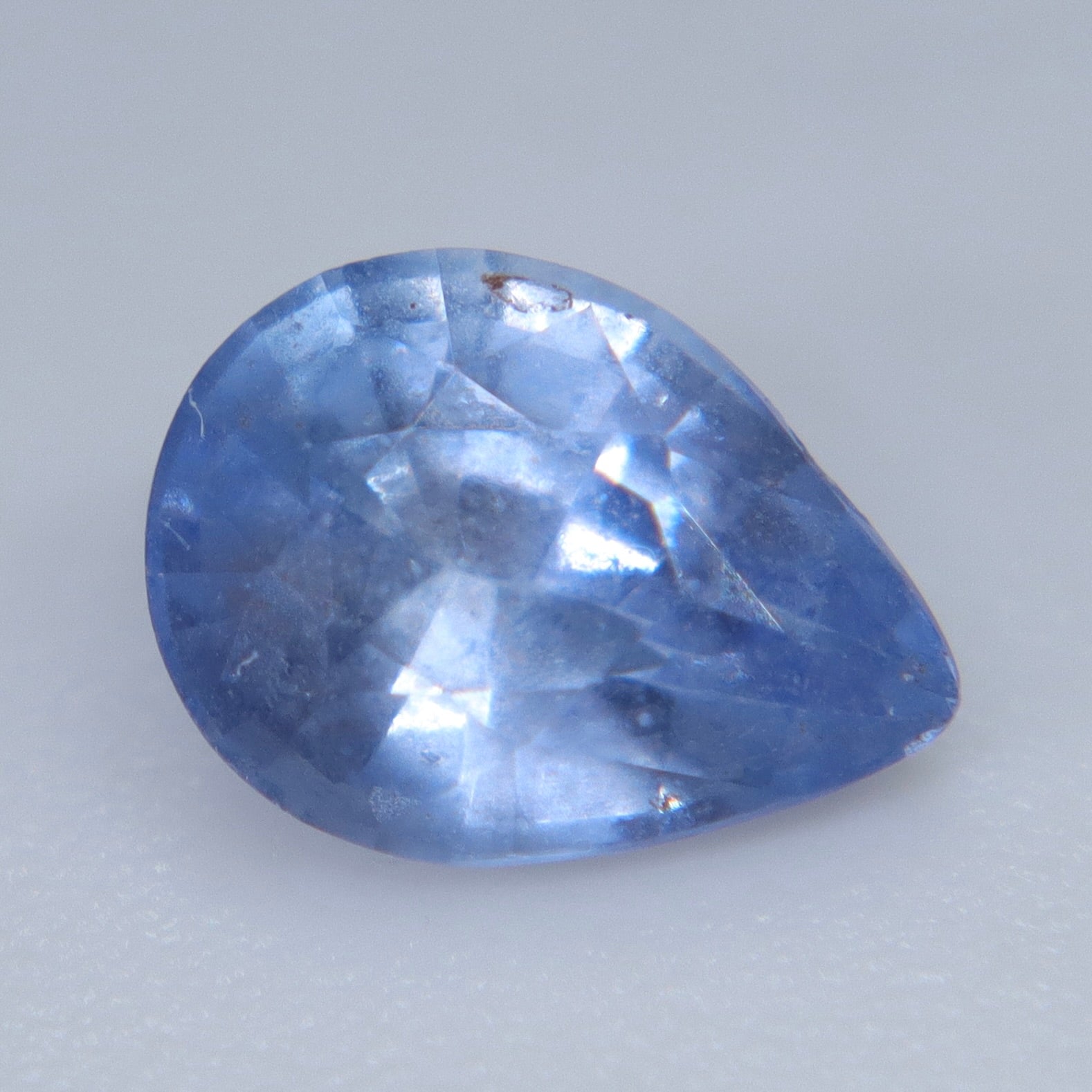 Pavilion view of a natural Ceylon blue sapphire showing the pear shape and polished facets