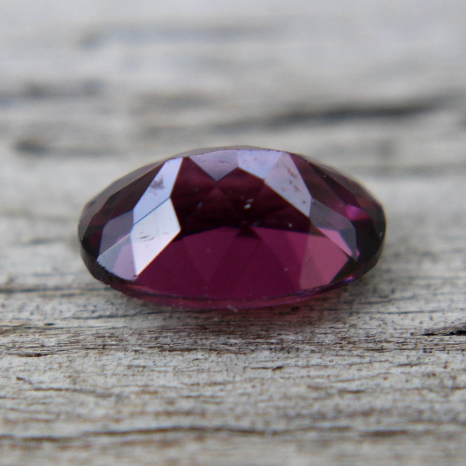 Ceylon pinkish purple spinel showing oval-cut facets and VVS clarity