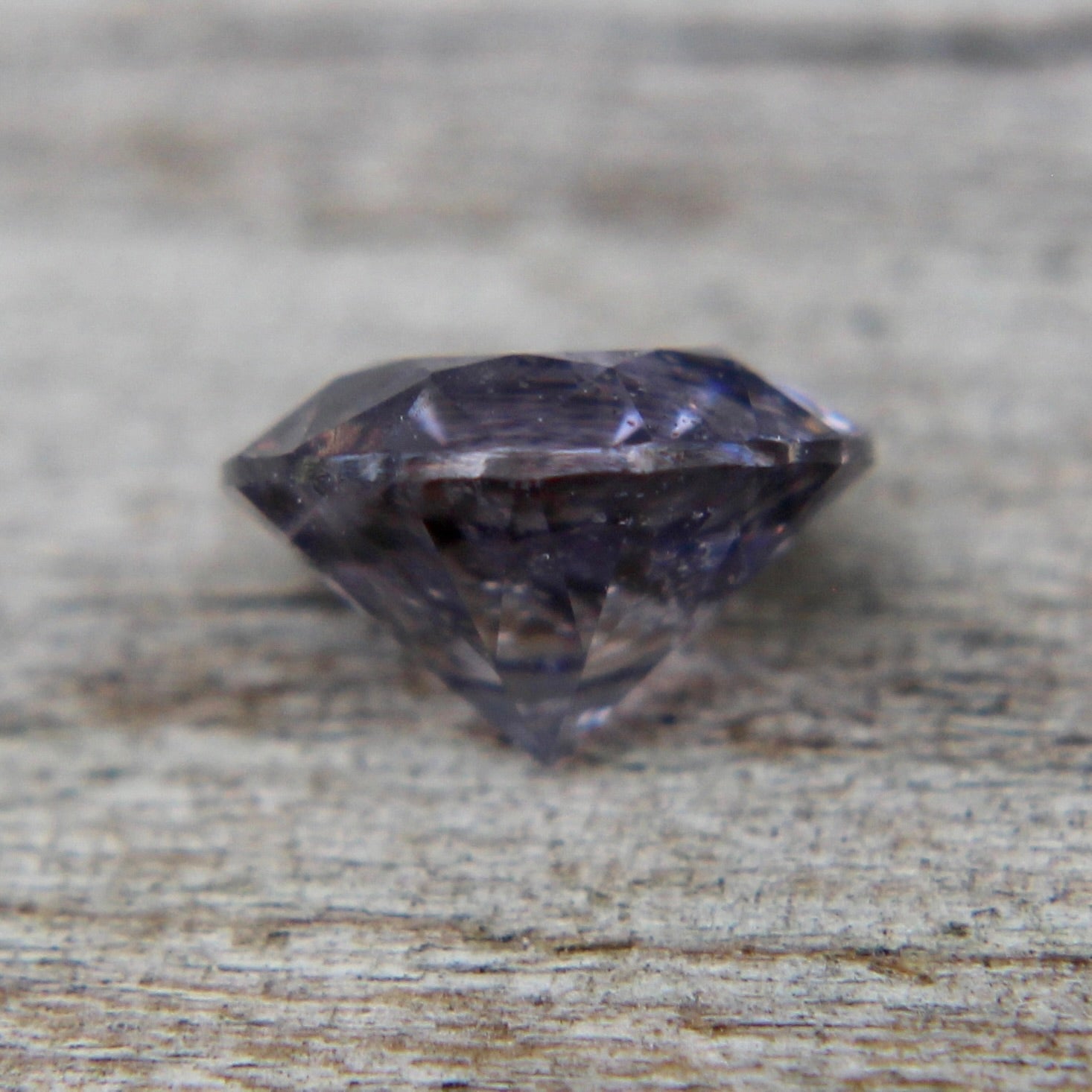 Side view of 6.04 mm round natural purple spinel from Ceylon