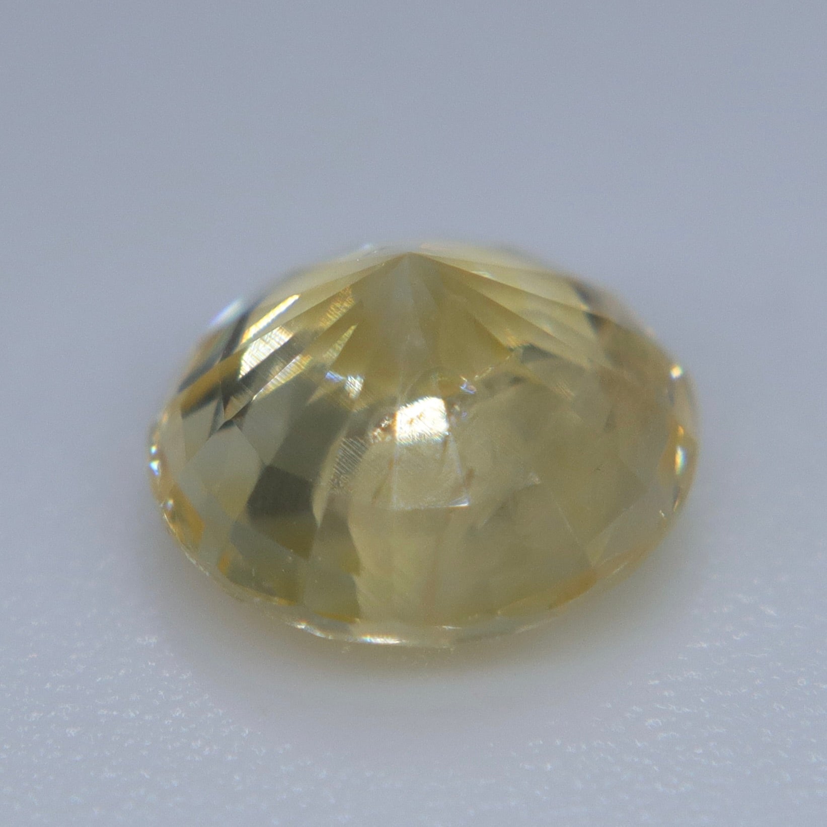 Pavilion view of a 1.29ct natural yellow sapphire from Ceylon showing its faceted round cut