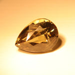Natural color-changing alexandrite showing red and purple tones under alternate lighting