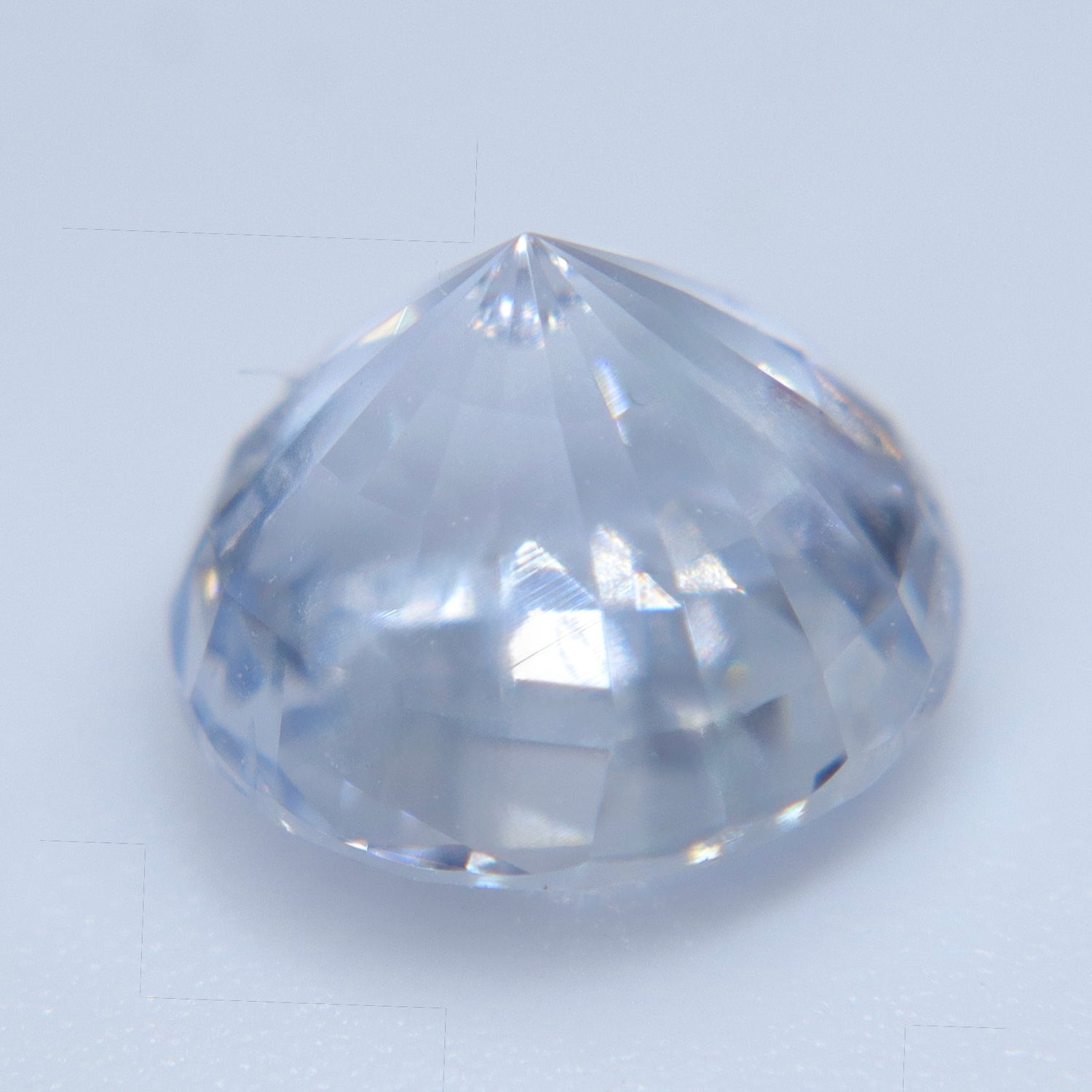 Face-up view of 3.11 carat colorless Ceylon sapphire showing round-cut brilliance