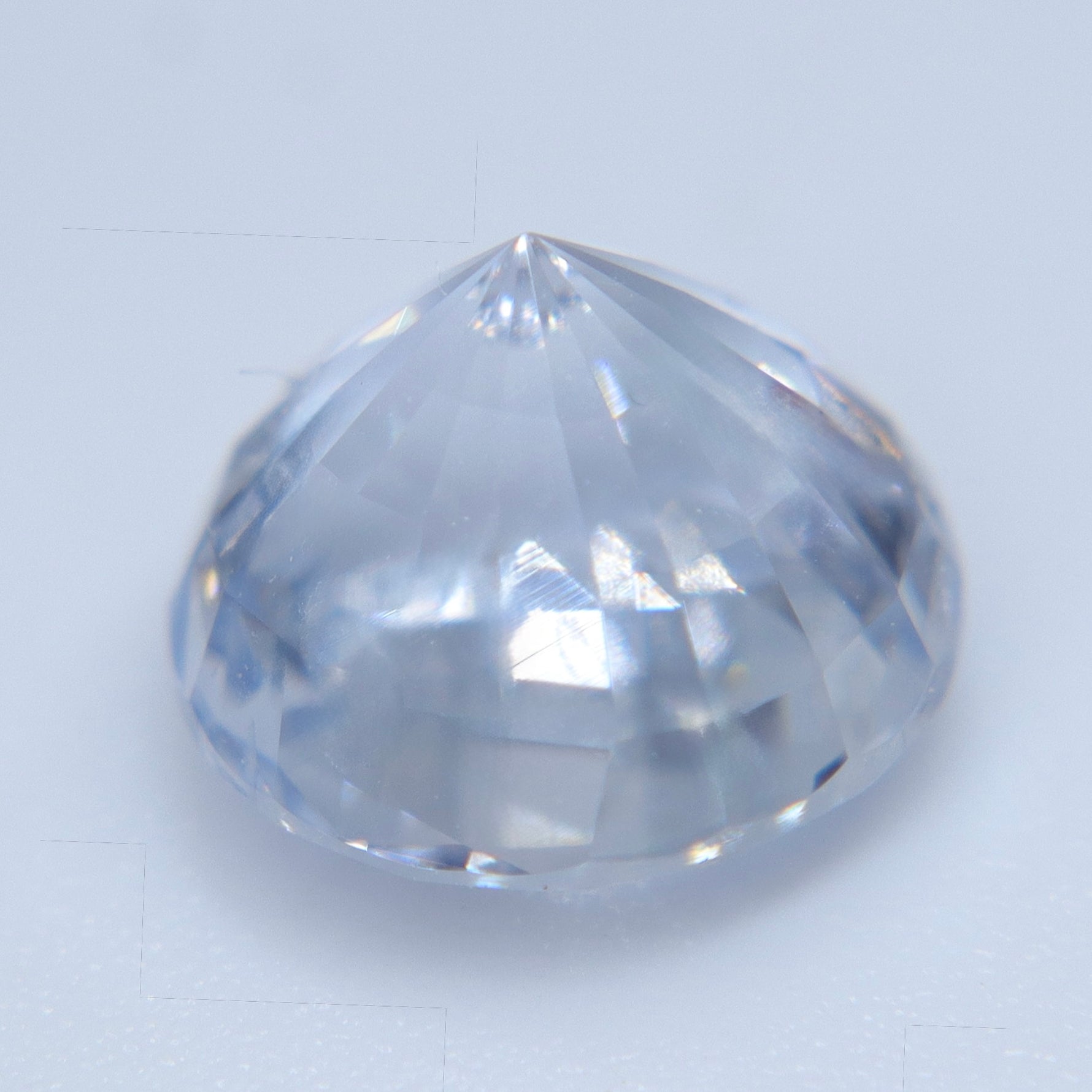 Face-up view of 3.11 carat colorless Ceylon sapphire showing round-cut brilliance