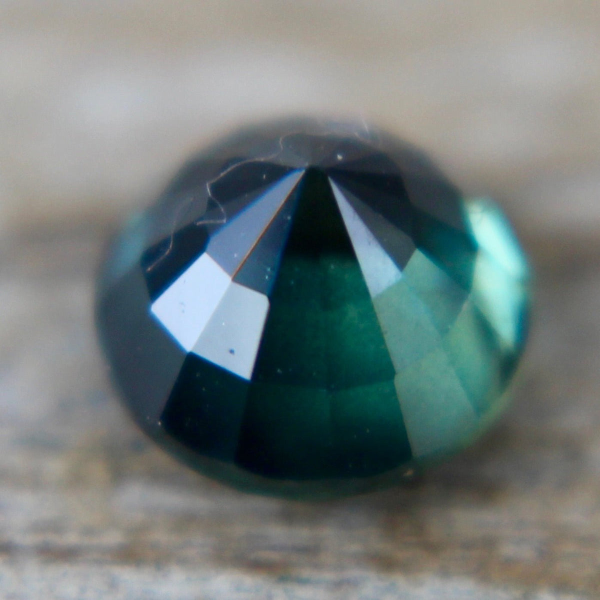 Angled view of a natural deep green sapphire from Madagascar