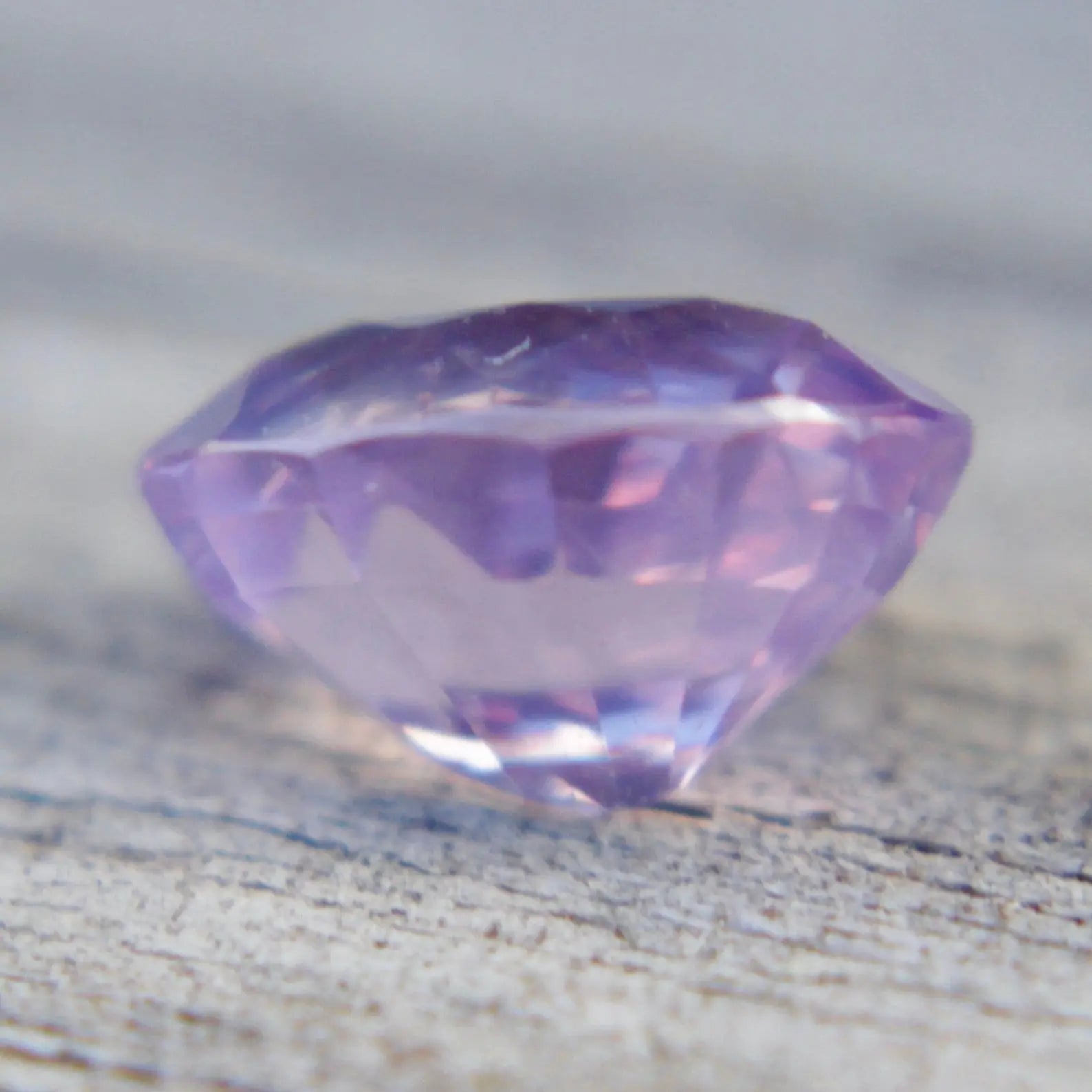 Eye-clean natural purplish pink oval sapphire viewed face-up