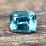 Underside view of a green cushion-cut sapphire showing its pavilion facets