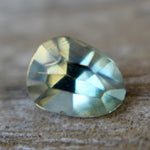 Side profile of a green trillion sapphire showing its 3.02 mm depth