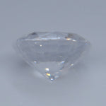Side view of heated natural white sapphire showing its round-cut profile
