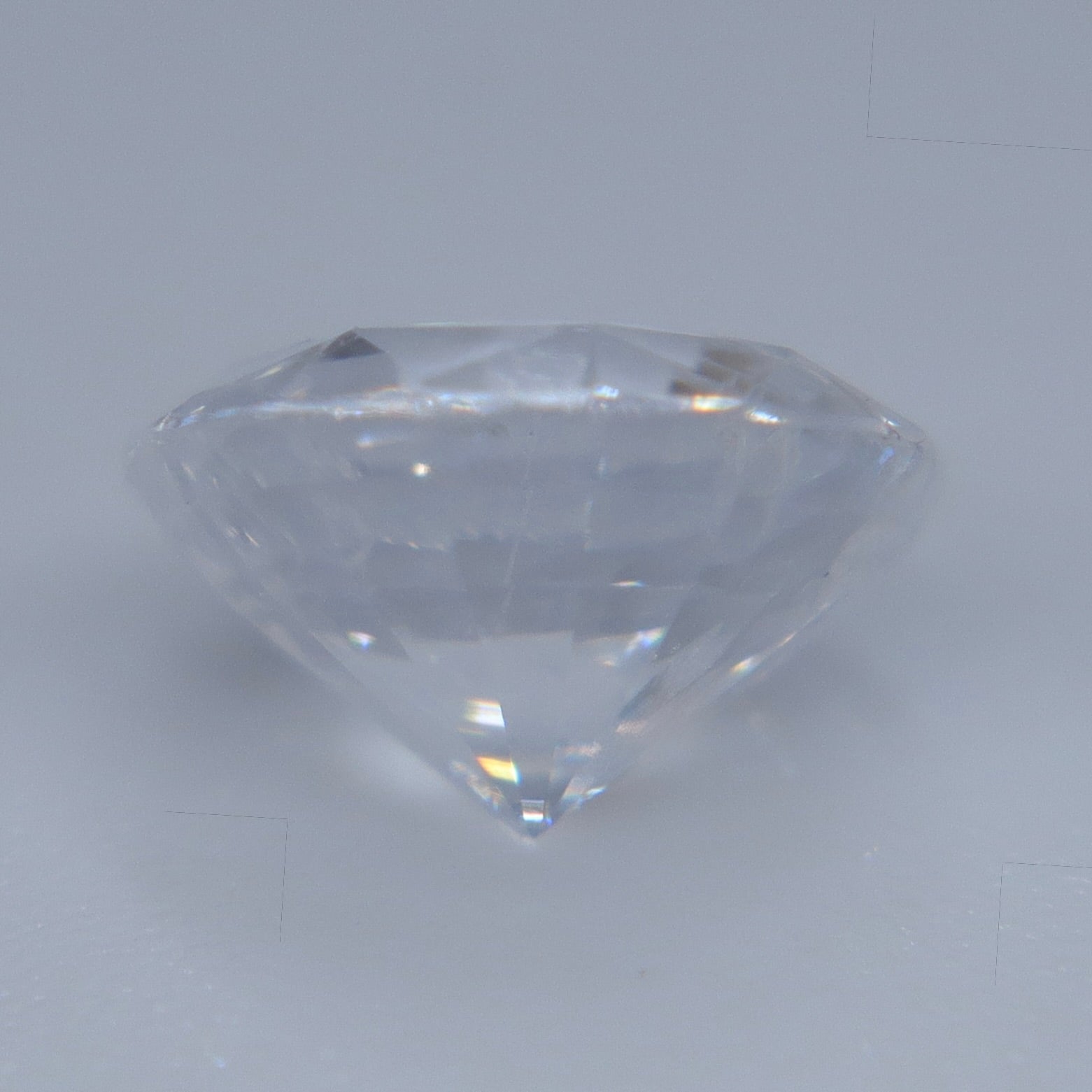 Side view of heated natural white sapphire showing its round-cut profile