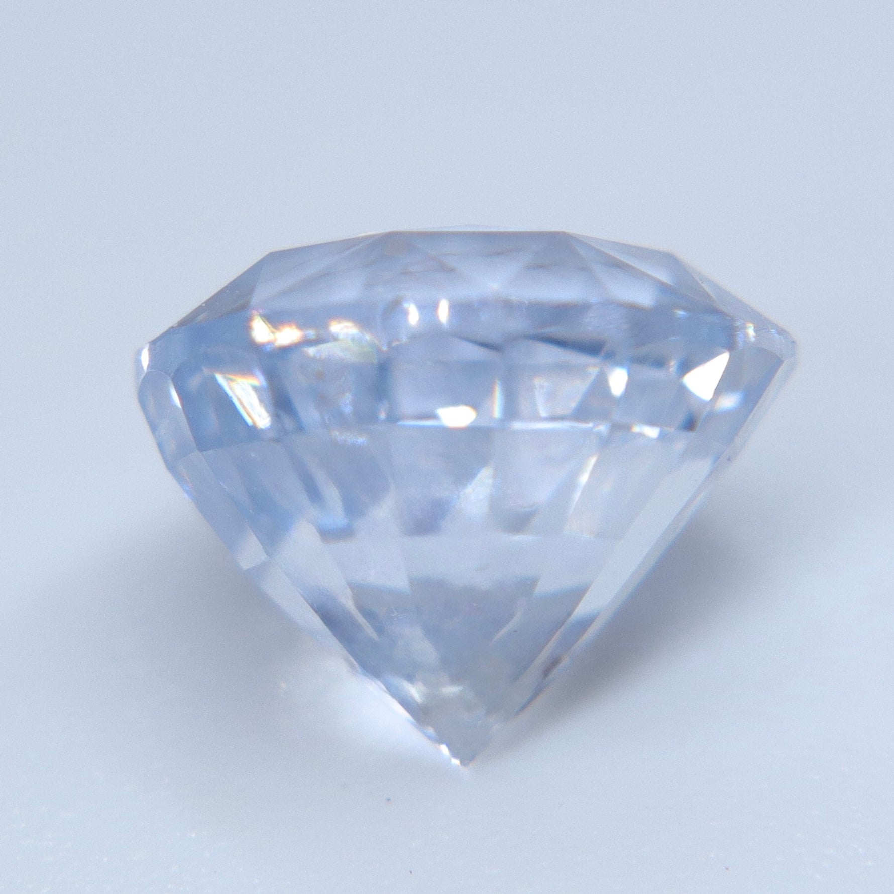 Side view of heated natural white sapphire measuring 8 mm in diameter
