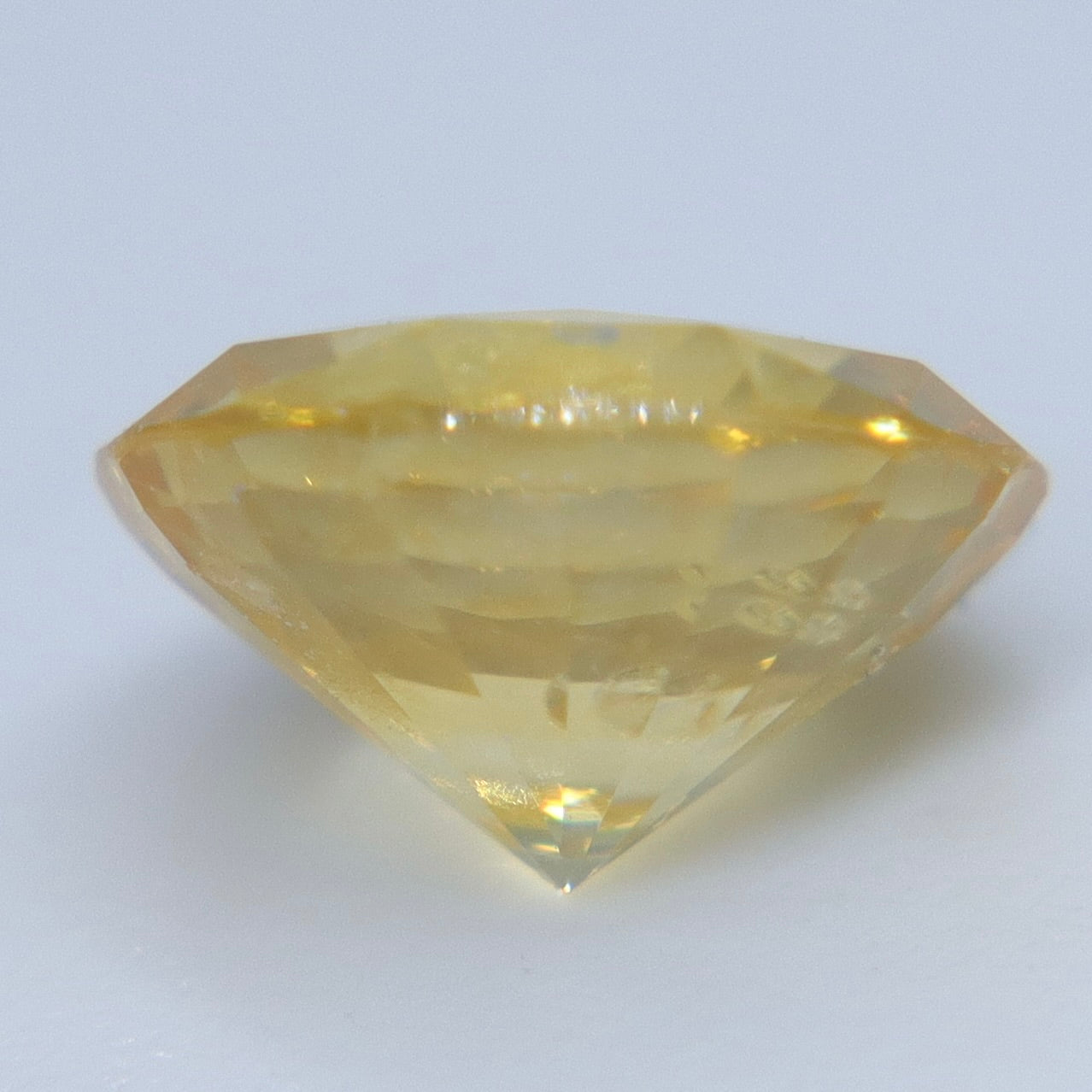 Heated 1.20ct Ceylon yellow sapphire showing its light golden color