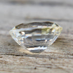 Ceylon champagne sapphire on calipers measuring 6.77 × 5.43 mm