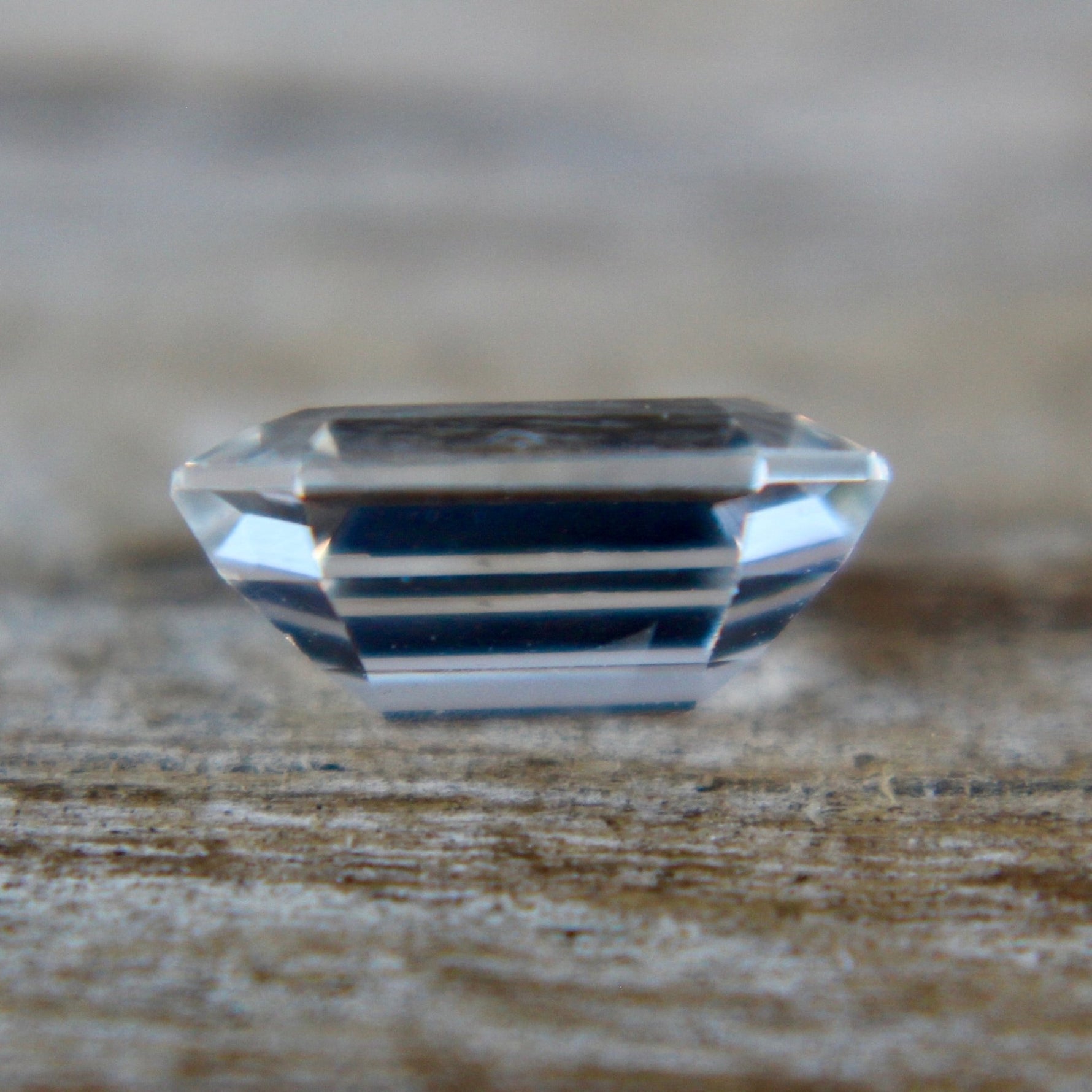 Emerald-cut colorless sapphire with bright step facets, earth sourced