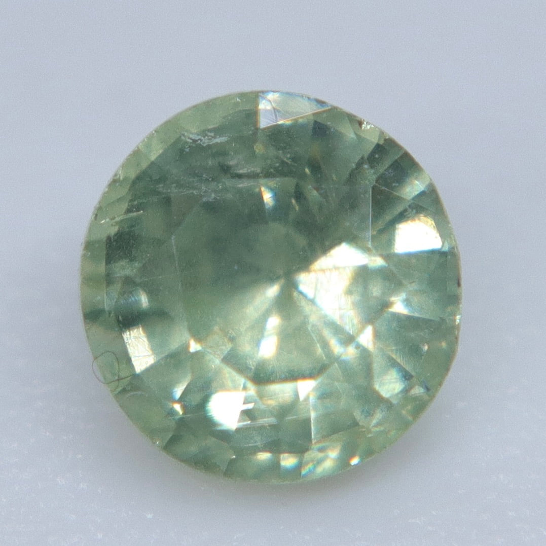 Pavilion view of an untreated Madagascar green sapphire showing its polished round facets