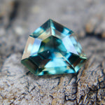 Ceylon teal sapphire on calipers measuring 6.92 × 5.75 mm