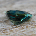 Modified trillion teal sapphire showing blue green color zoning and bright facets