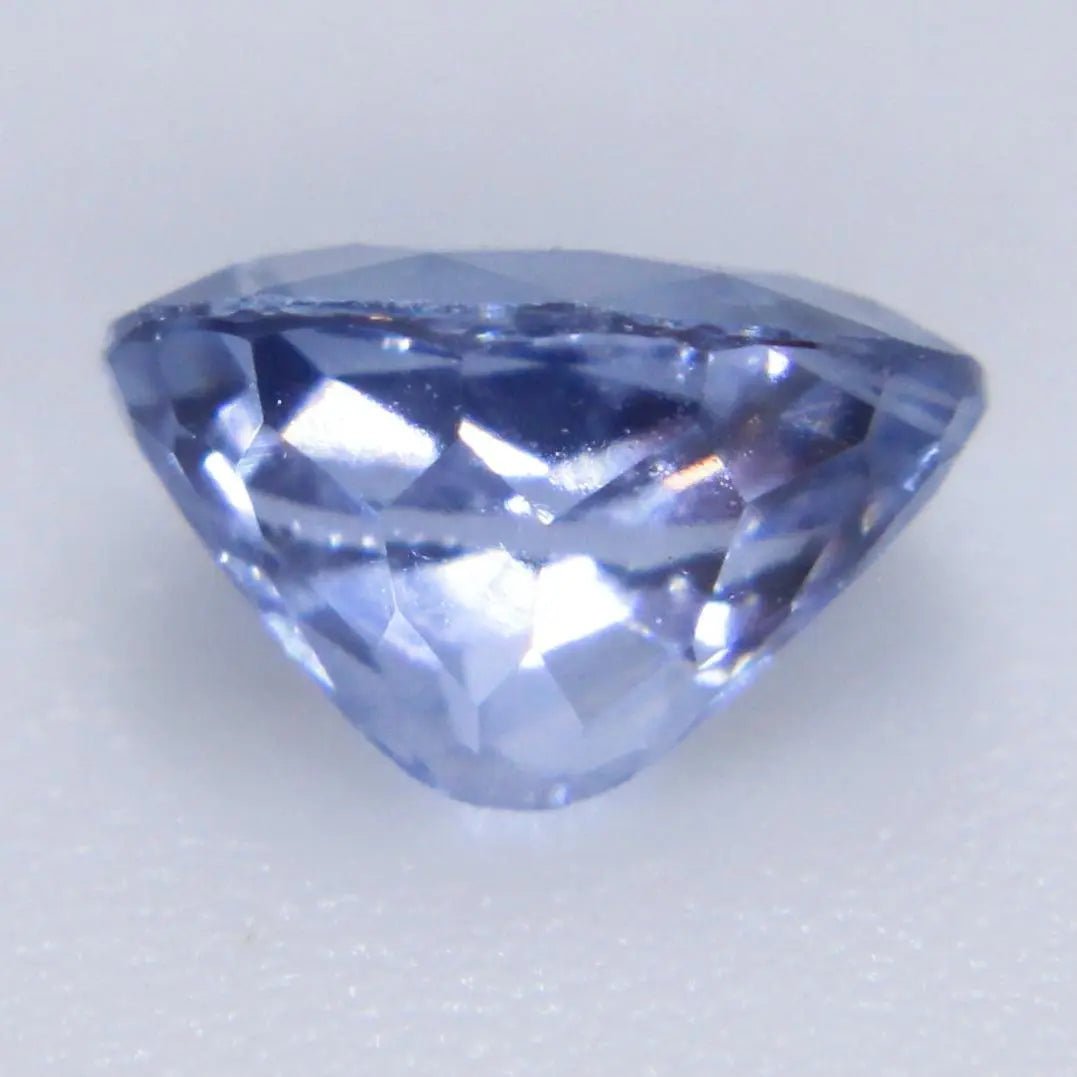 Oval blue sapphire with calipers: 5.92 × 4.18 × 3.51 mm