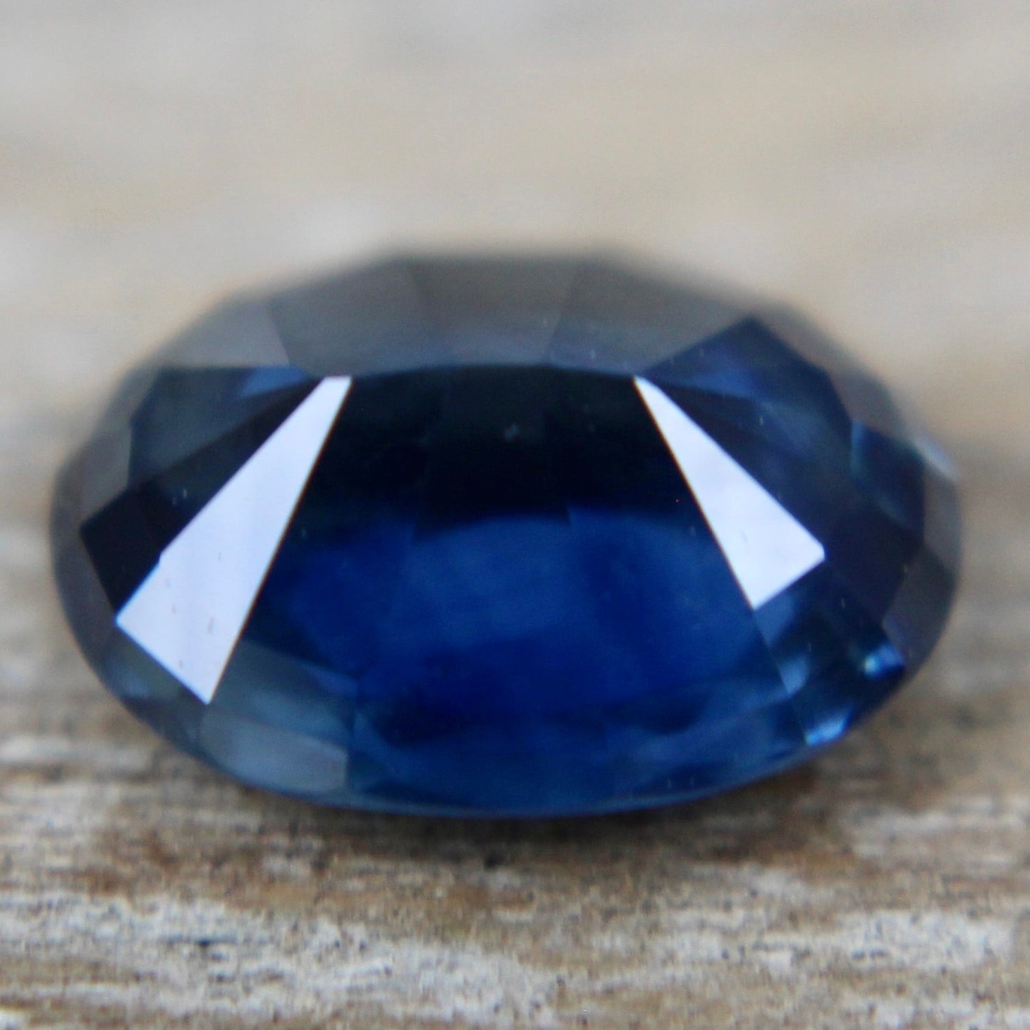 Oval blue sapphire showing bright faceting and deep color