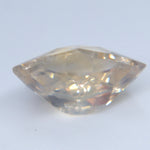 Angled view of the untreated Ceylon sapphire showing its asymmetric shape and pale champagne tone