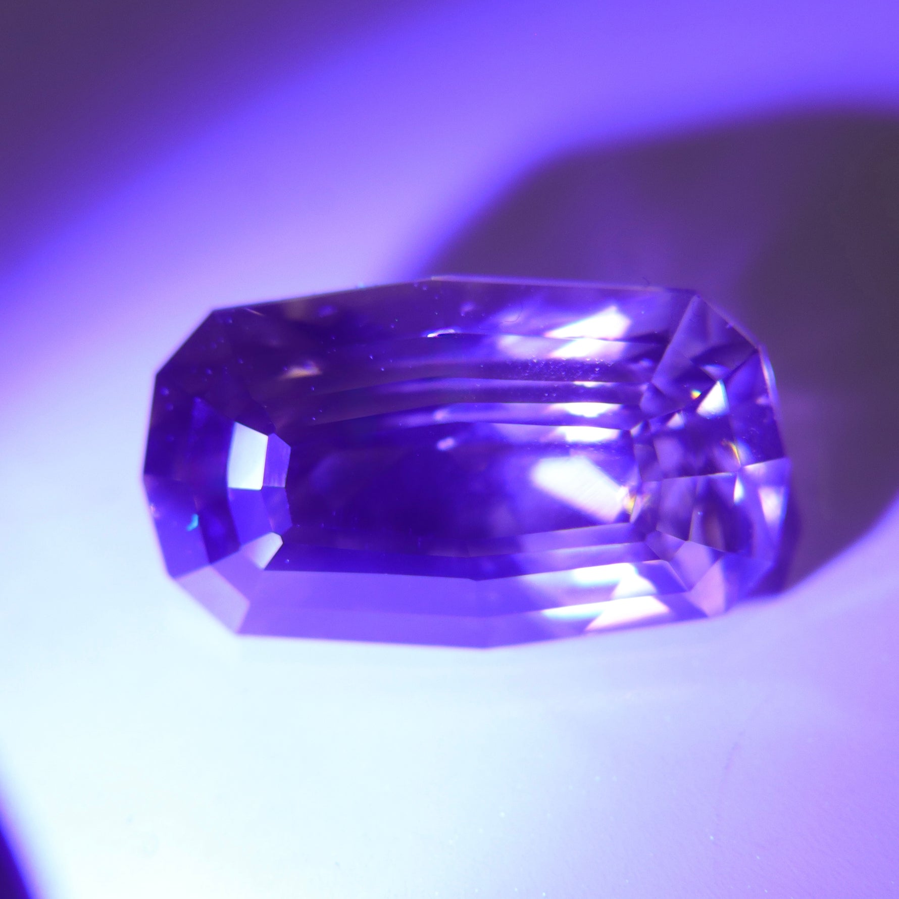 Natural chrysoberyl appearing golden yellow under warm lighting