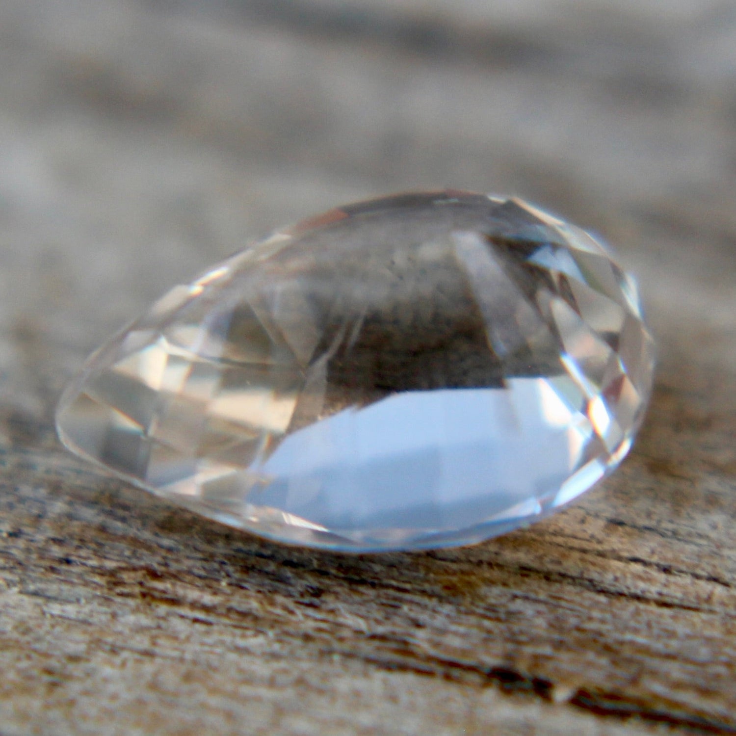 1.05ct Ceylon colorless (white) sapphire, pear cut, unheated untreated, VS clarity — macro under daylight