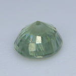 Side profile of a 0.34ct natural green sapphire showing its round faceting and 2.80 mm depth