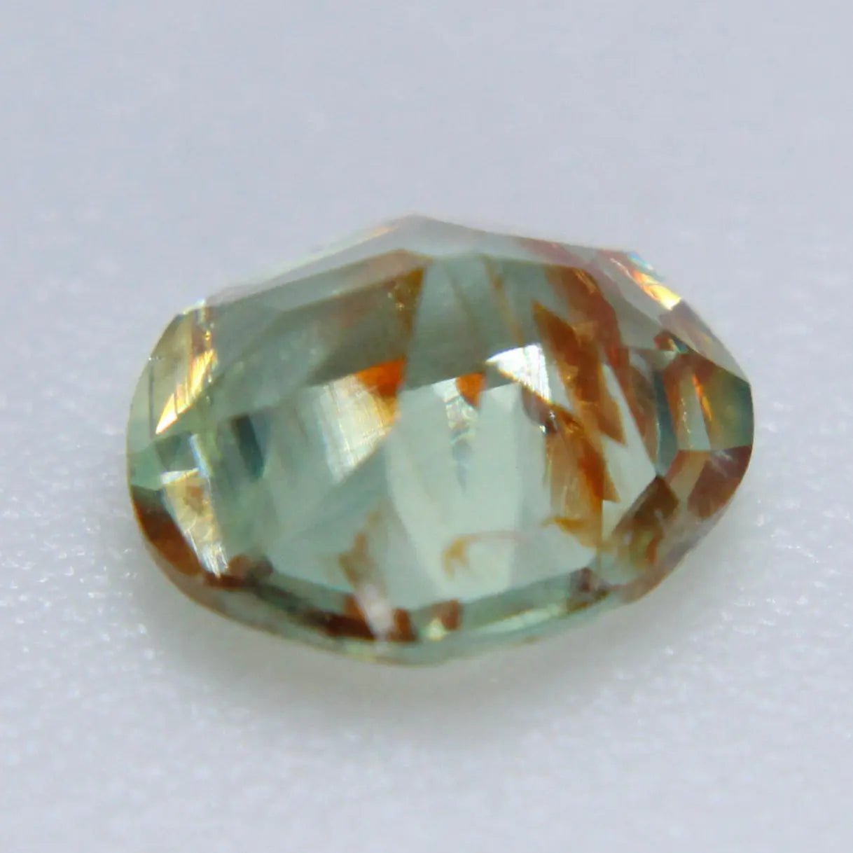 Untreated natural green sapphire freeform faceted gemstone close up