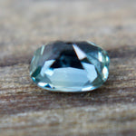 Cushion cut green sapphire 0.80 carat showing lively facets in neutral lighting