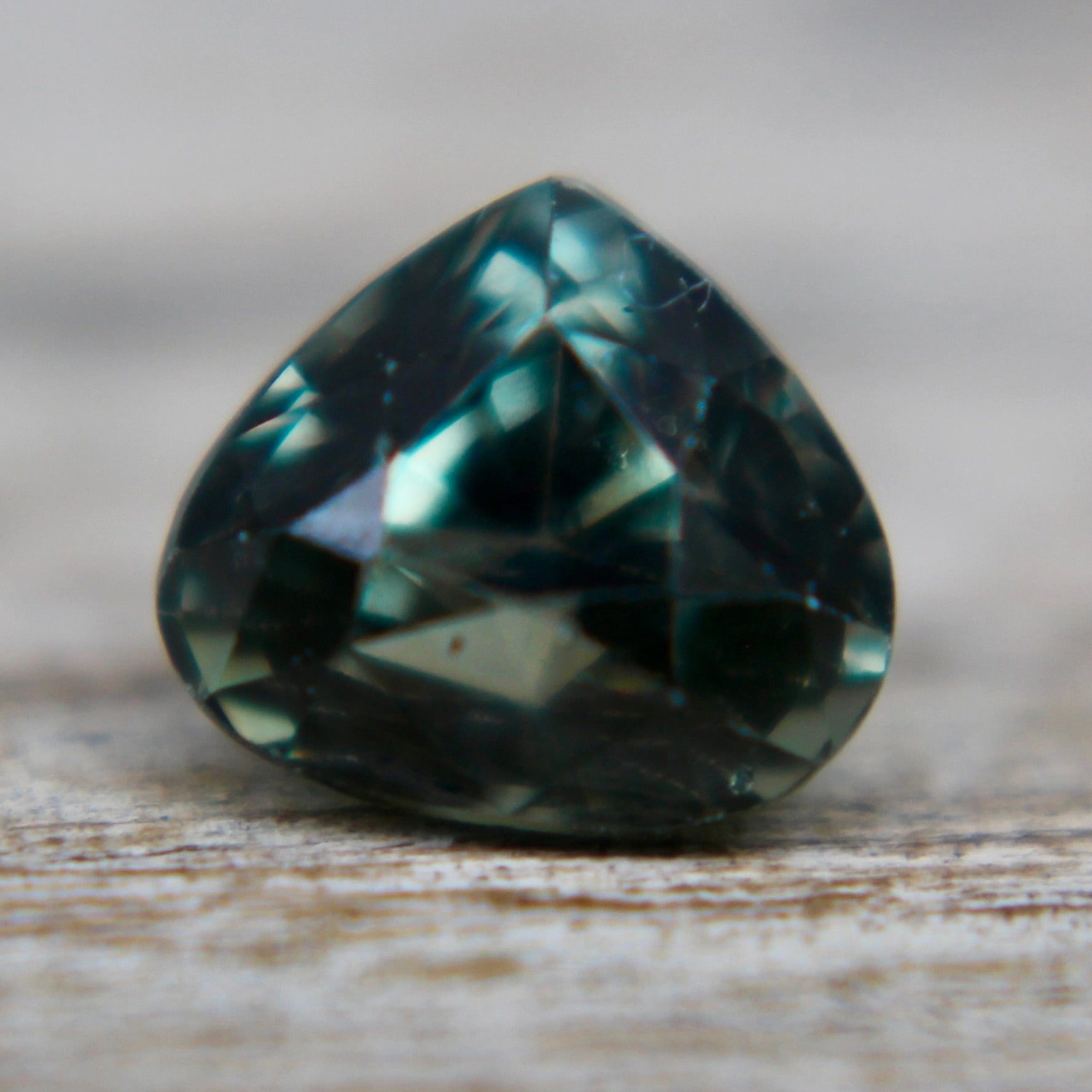 Faceted pear-cut green sapphire with bright saturation