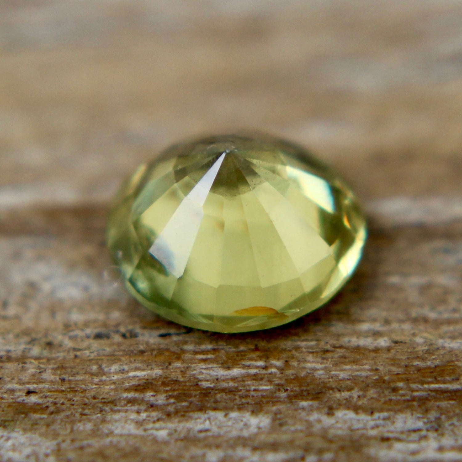 Round green sapphire with bright scintillation and precision faceting