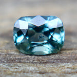 Loose green sapphire measured on calipers at 5.70 × 4.30 mm, SI clarity