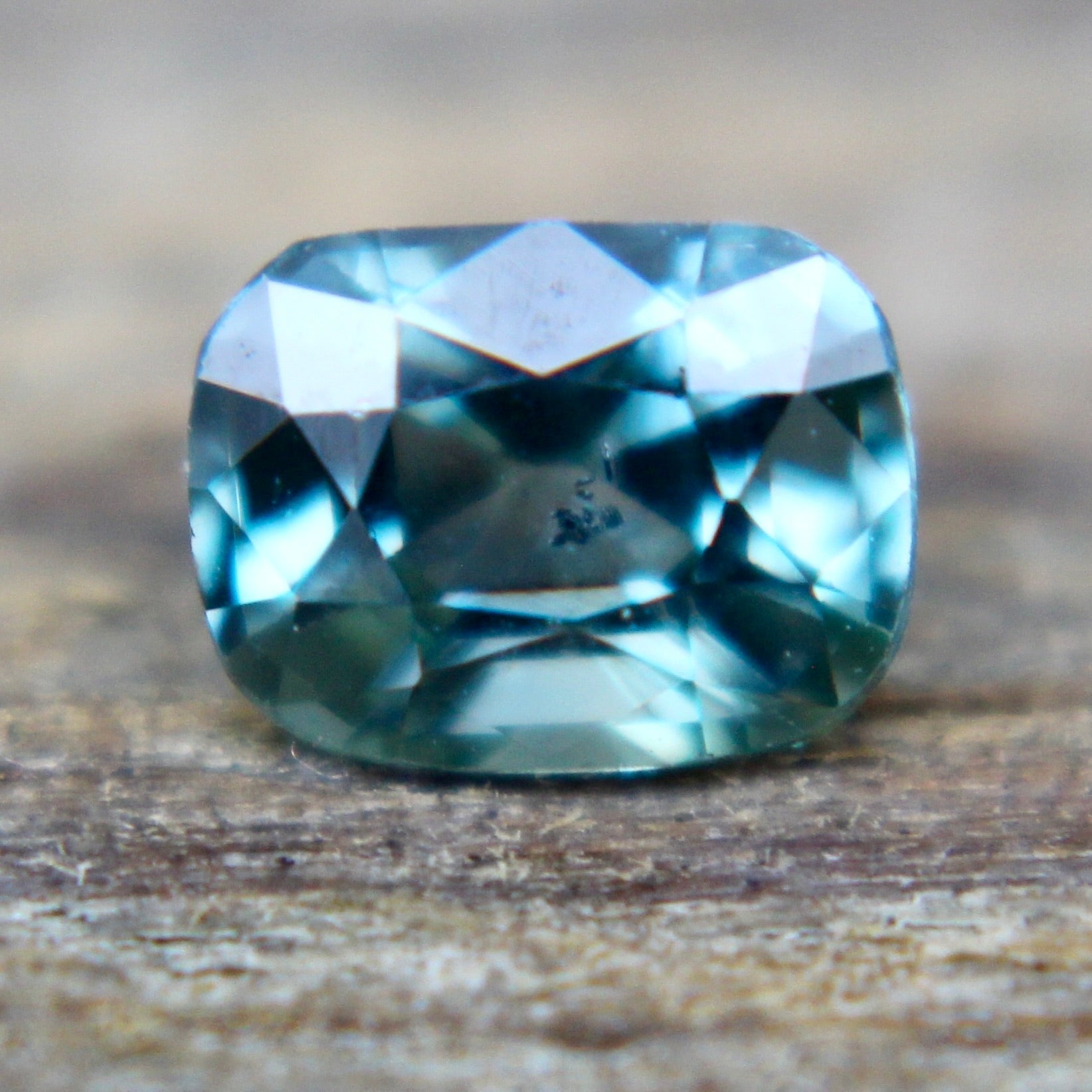 Loose green sapphire measured on calipers at 5.70 × 4.30 mm, SI clarity