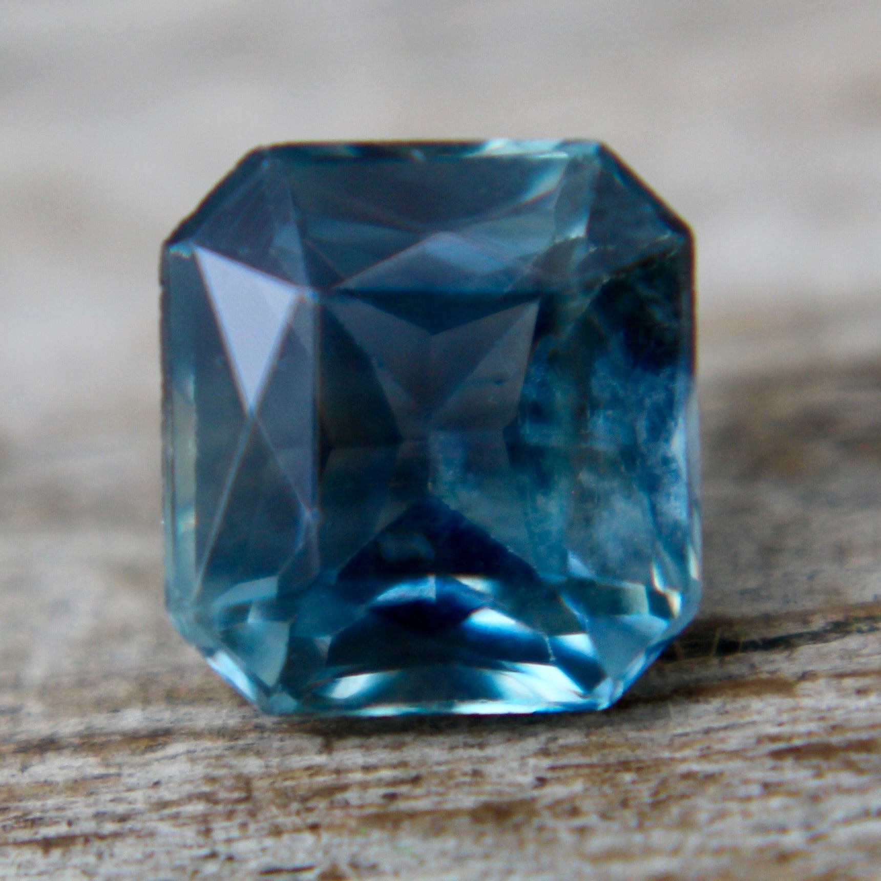 Loose emerald-cut green sapphire for engagement ring