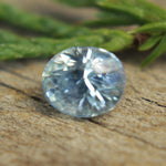 Faceted gemstone macro — natural pale blue sapphire oval cut