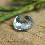 Face-up view — 5.95×5.09mm oval pale blue sapphire with bright sparkle