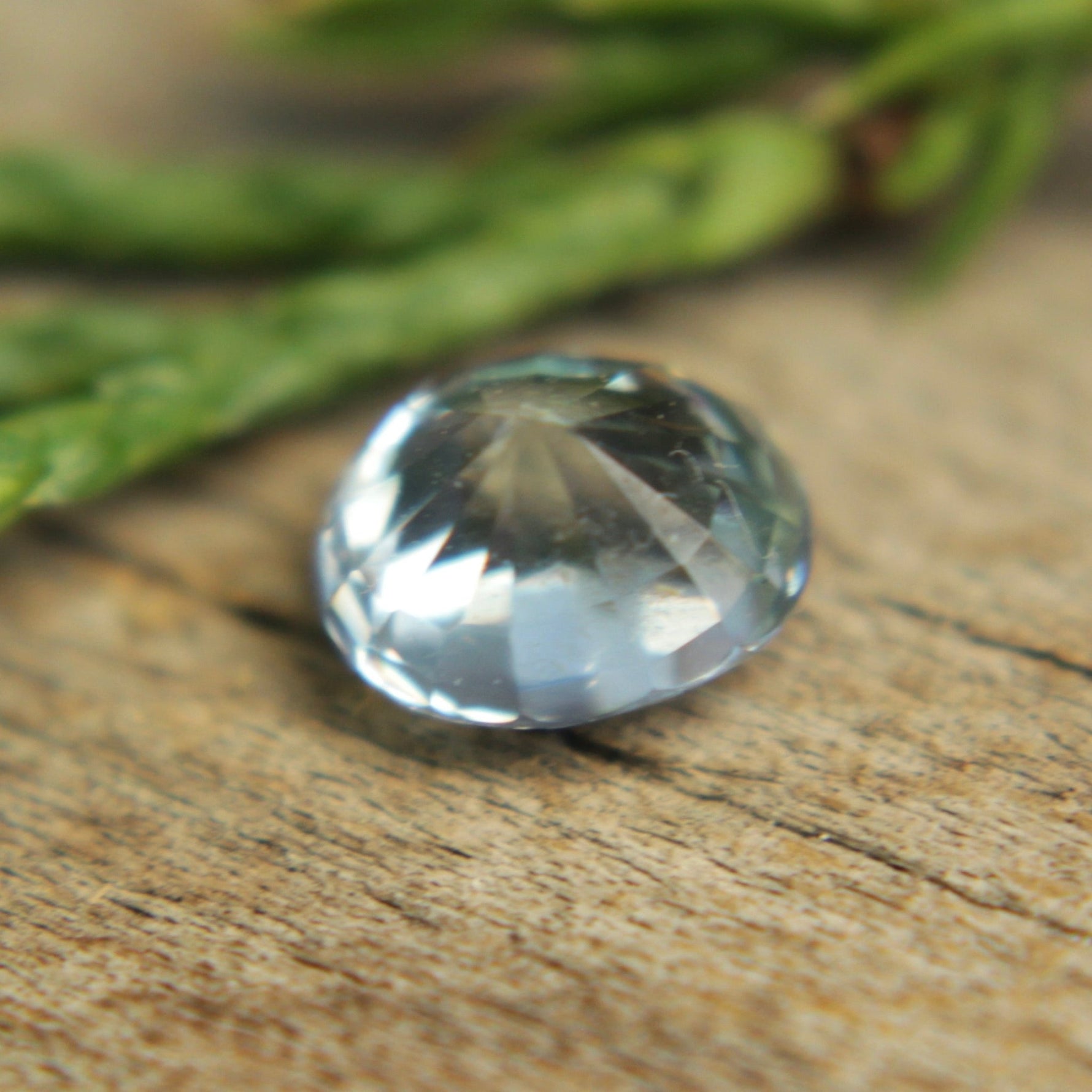 Face-up view — 5.95×5.09mm oval pale blue sapphire with bright sparkle