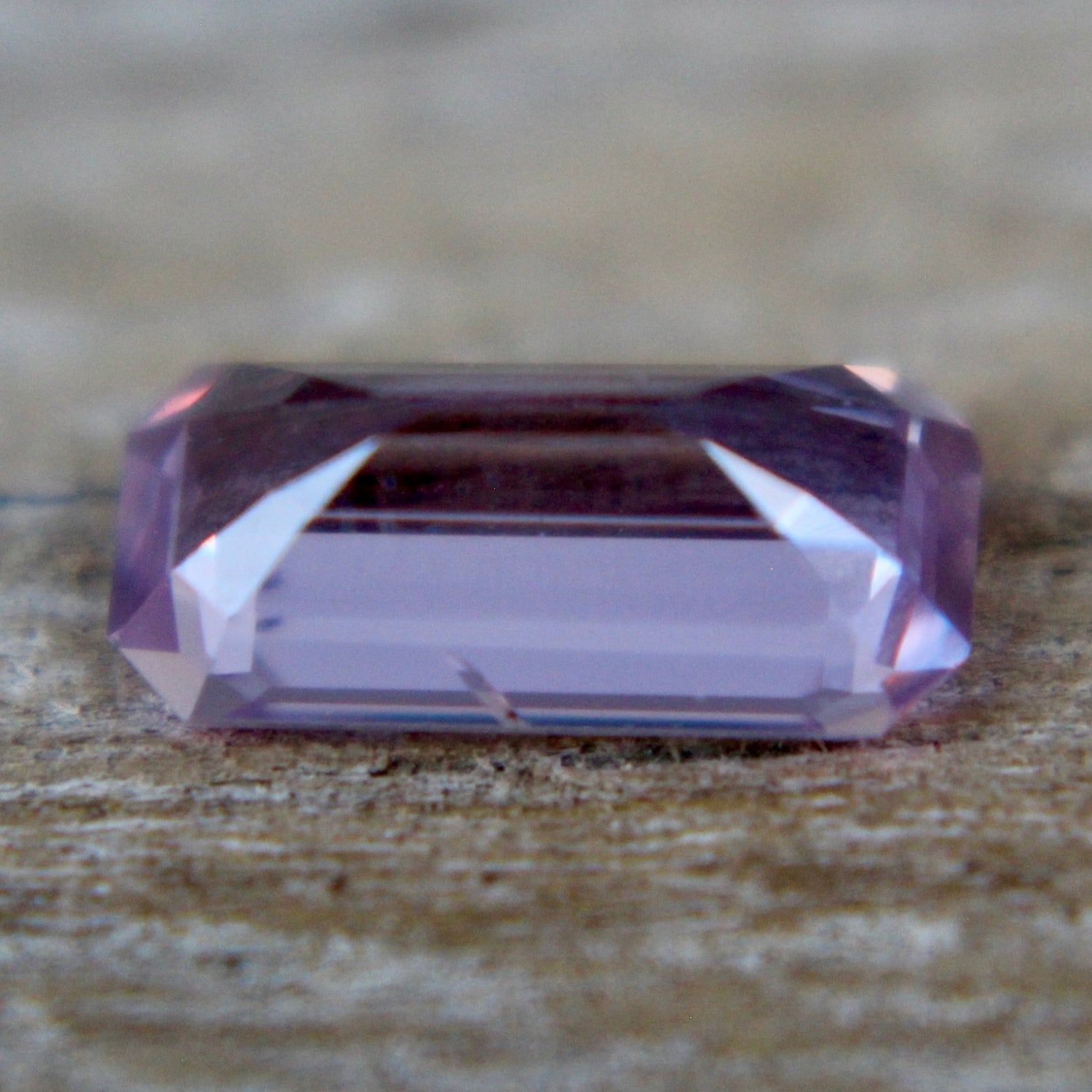 Earth-sourced emerald-cut pink sapphire for bespoke engagement rings — precision step-cut gemstone
