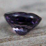 Ceylon purple spinel on calipers at 7.54 × 6.10 mm