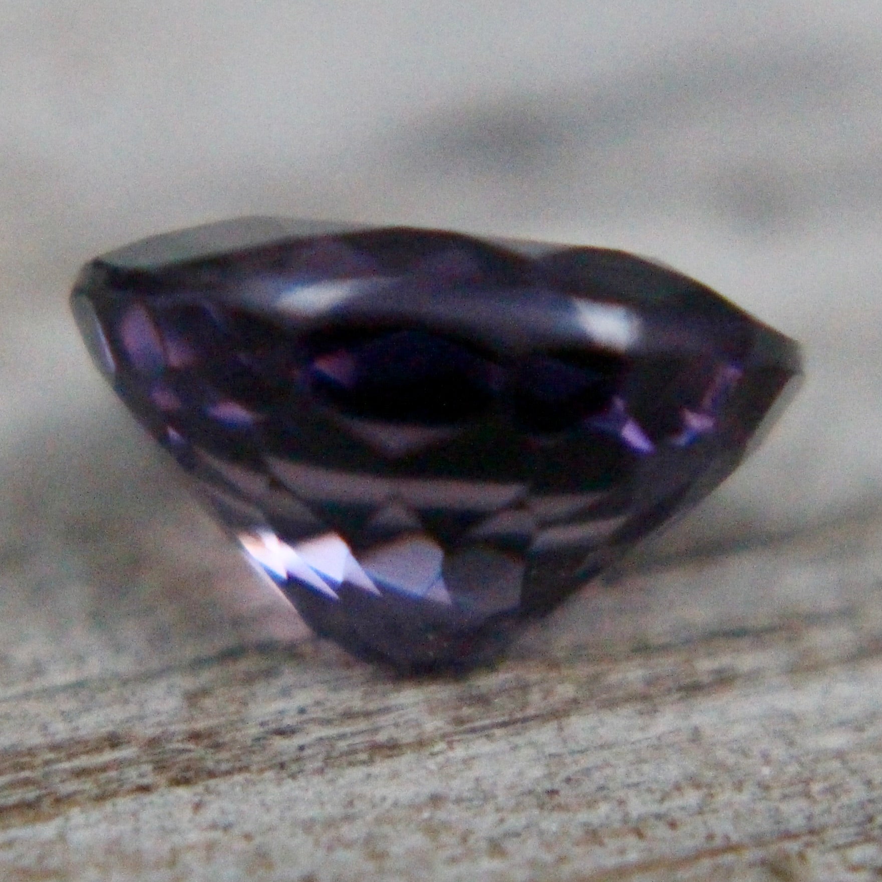 Ceylon purple spinel on calipers at 7.54 × 6.10 mm