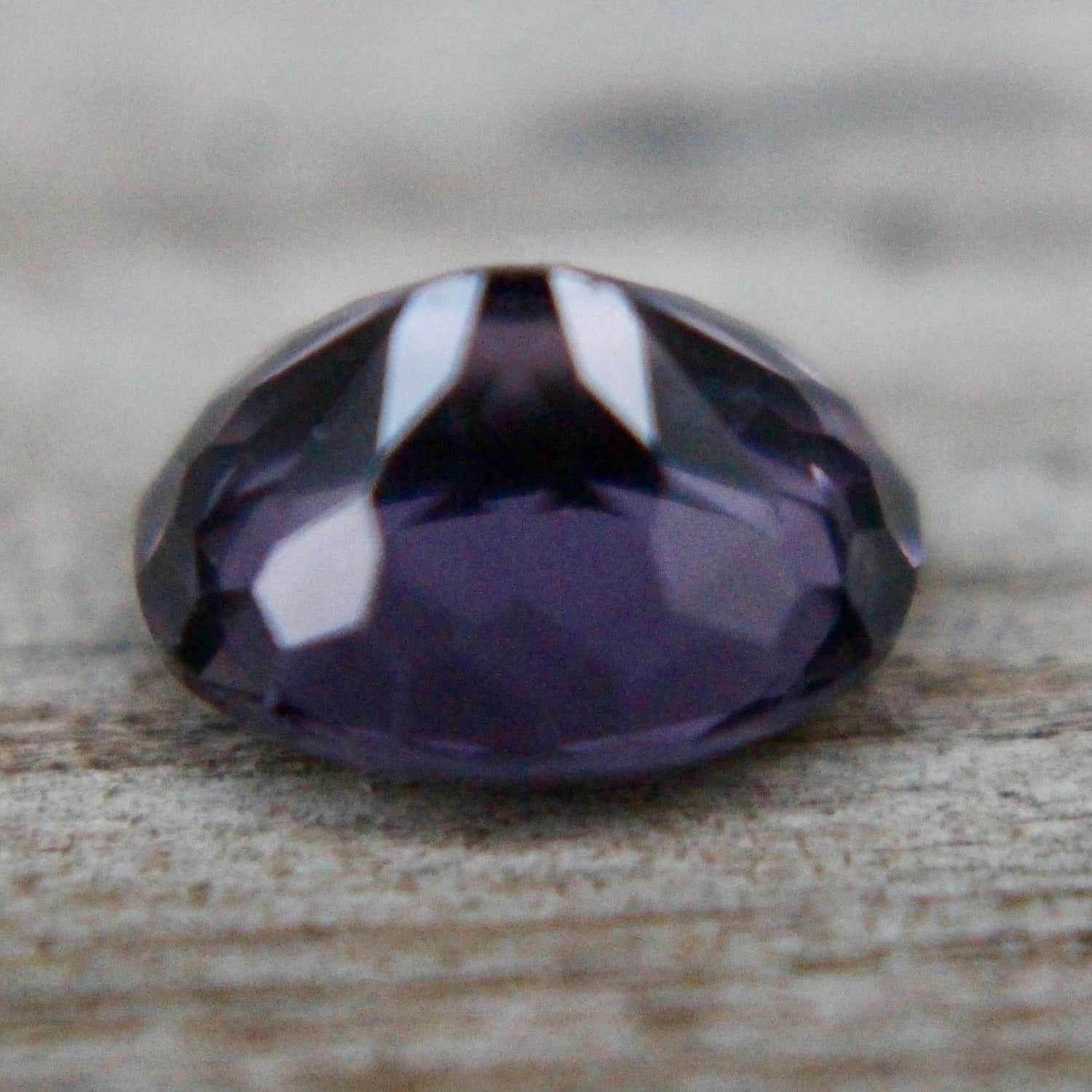 Oval purple spinel showing lavender-violet hue and precision faceting