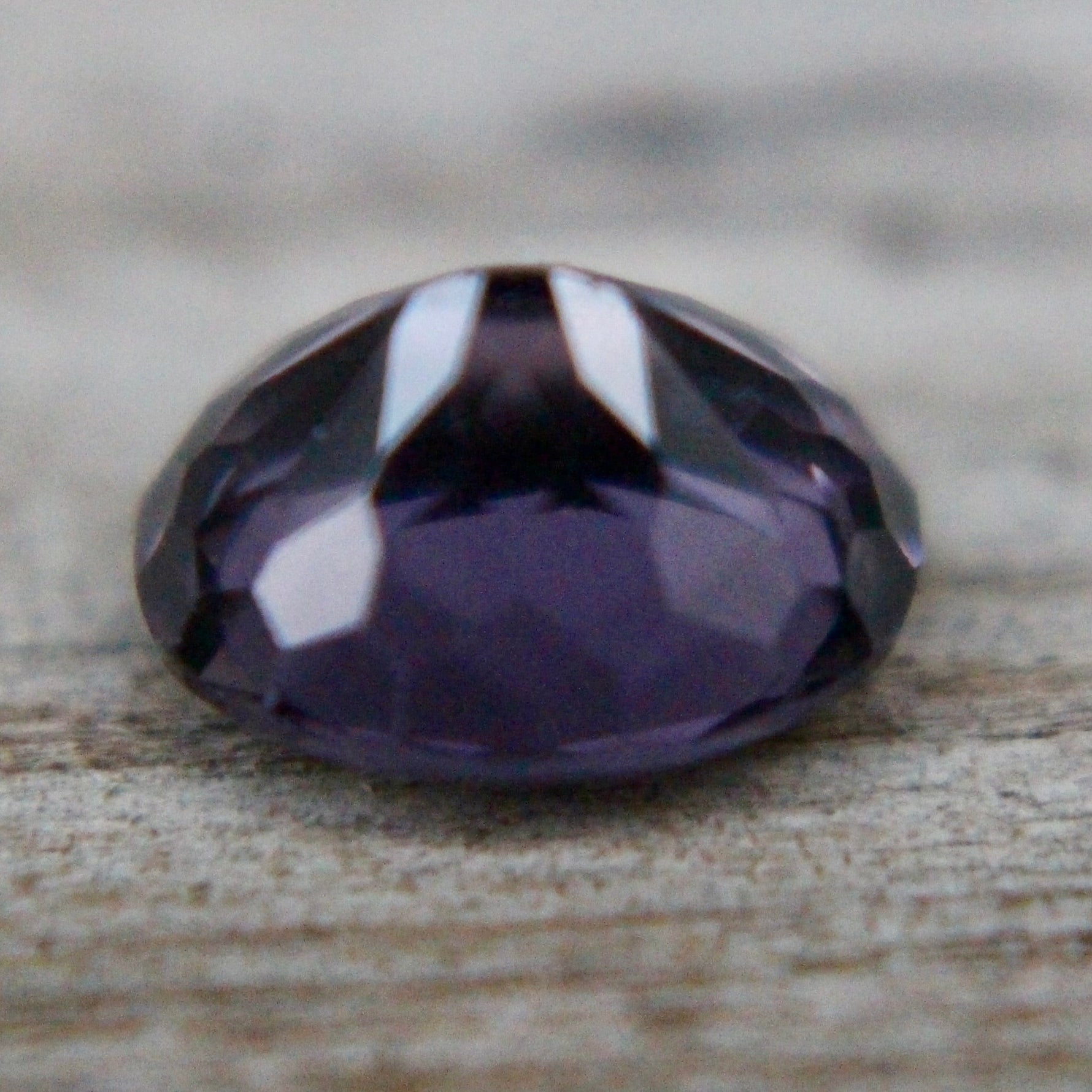 Oval purple spinel showing lavender-violet hue and precision faceting