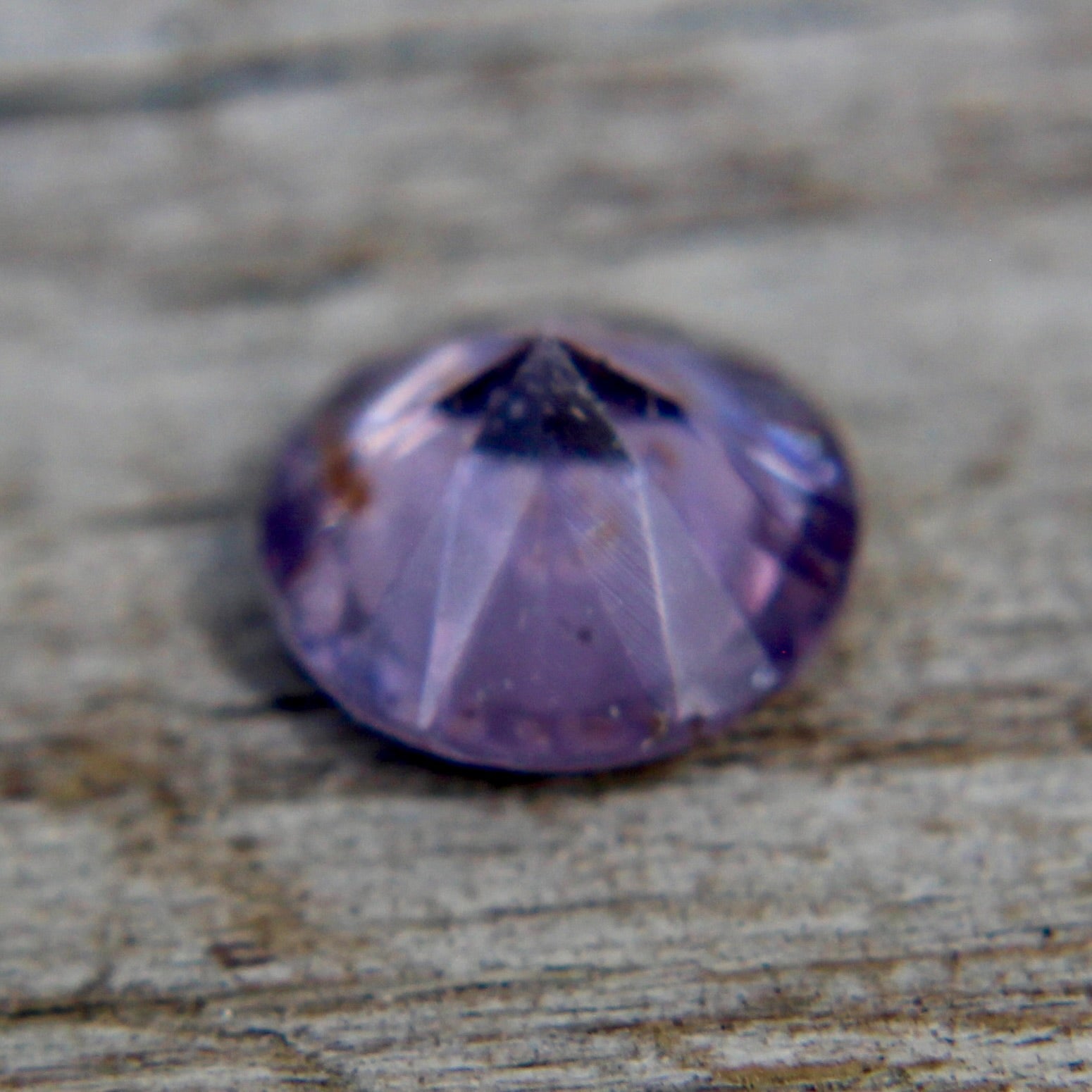 Round purple spinel showing vivid lavender-violet hue and fine faceting