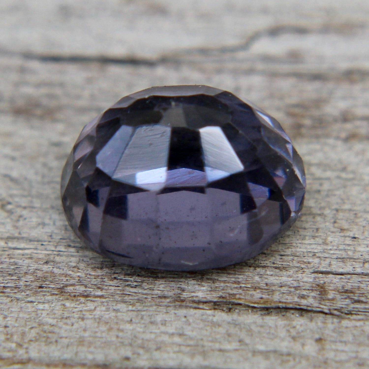 Oval purple spinel showing vivid lavender-violet hue and precision faceting