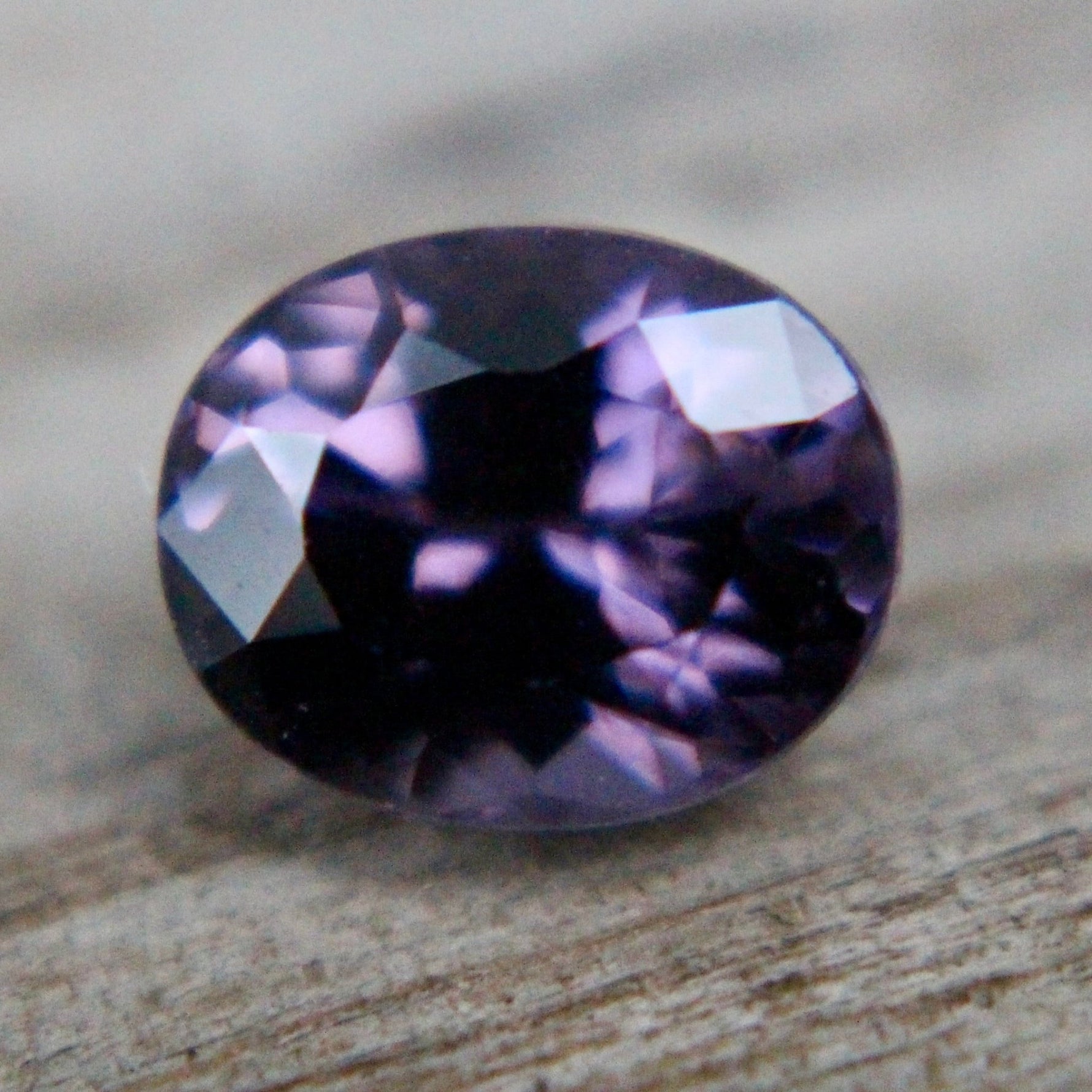 Side profile of untreated VS purple spinel, oval cut