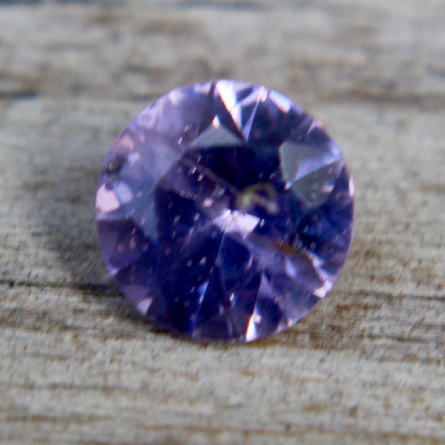 Round purple spinel showing vivid lavender-violet hue and fine faceting