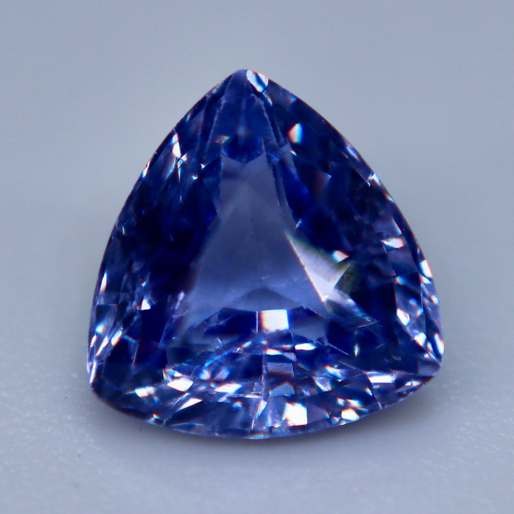 Natural purple trillion-cut sapphire shown from the side