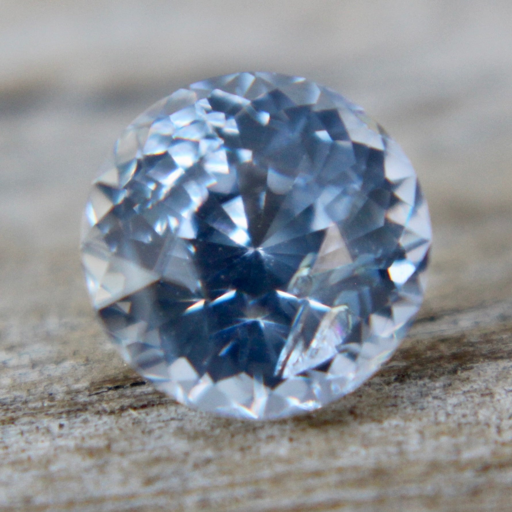 High clarity 1.45ct round cut white sapphire with soft blue hue