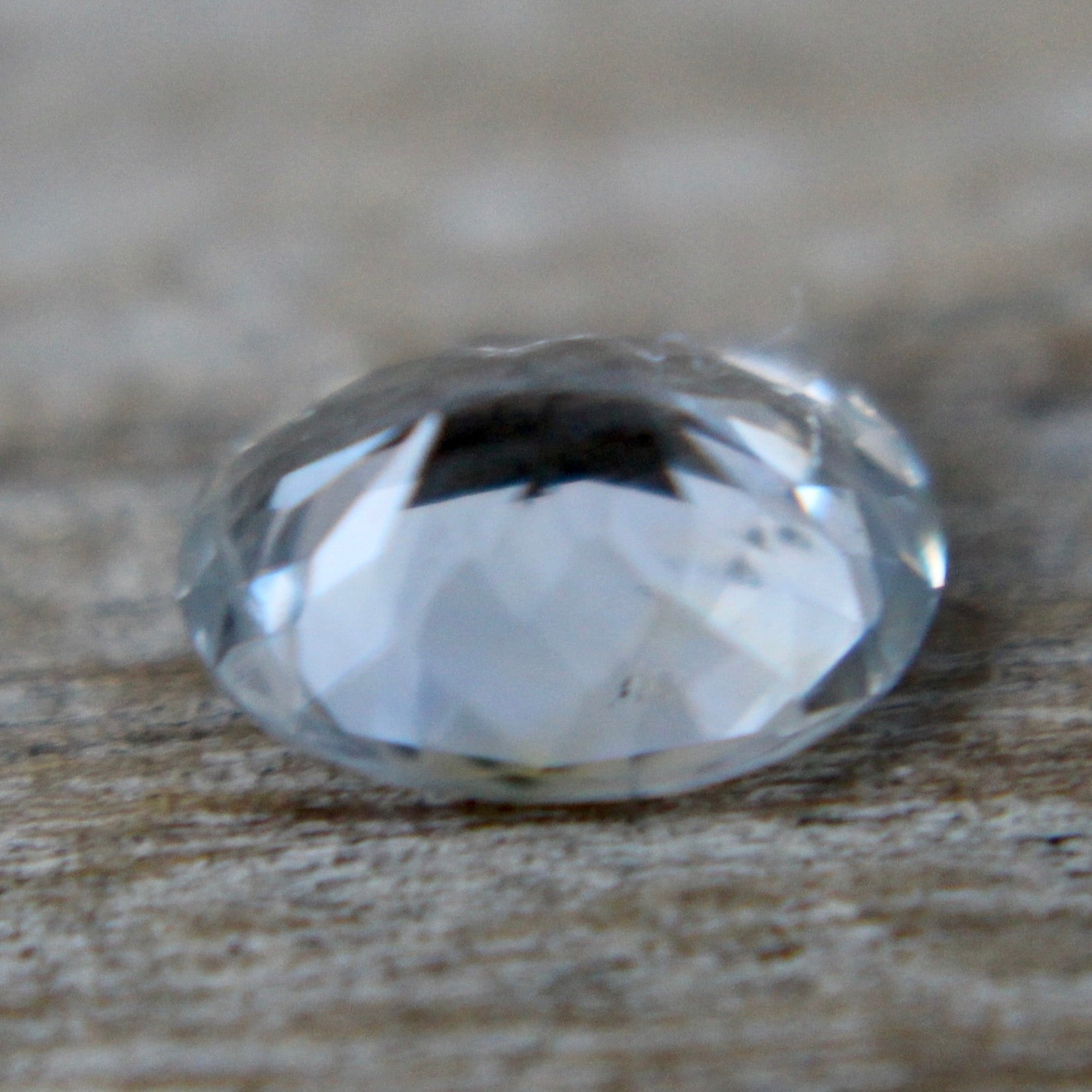 Unheated white sapphire oval gemstone with slight blue tone
