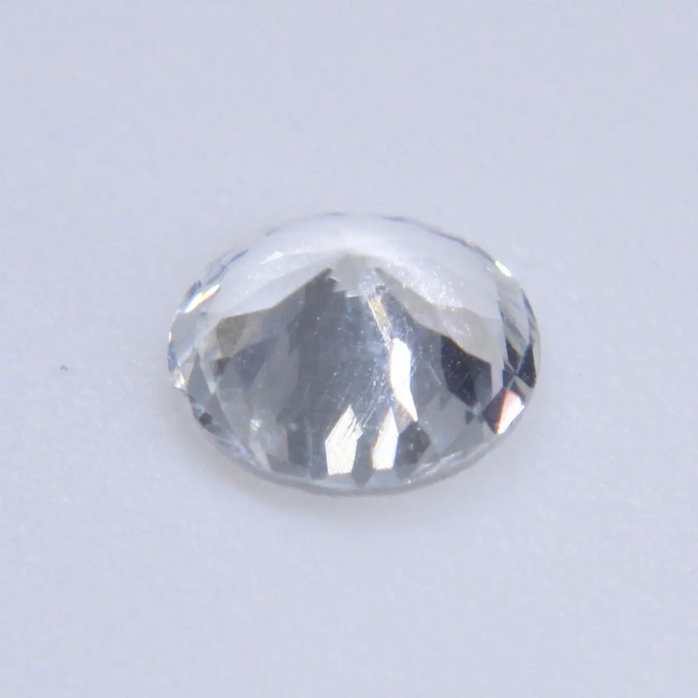 Natural round cut white sapphire with authenticity confirmation